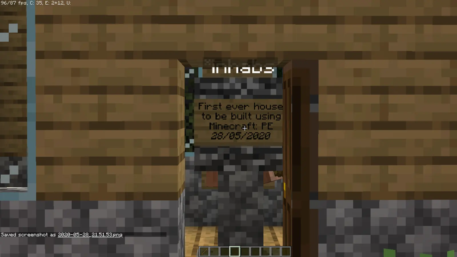 The first player house built on Peaceful Vanilla Club through the experimental Geyser proxy, with a sign dated May 2020
